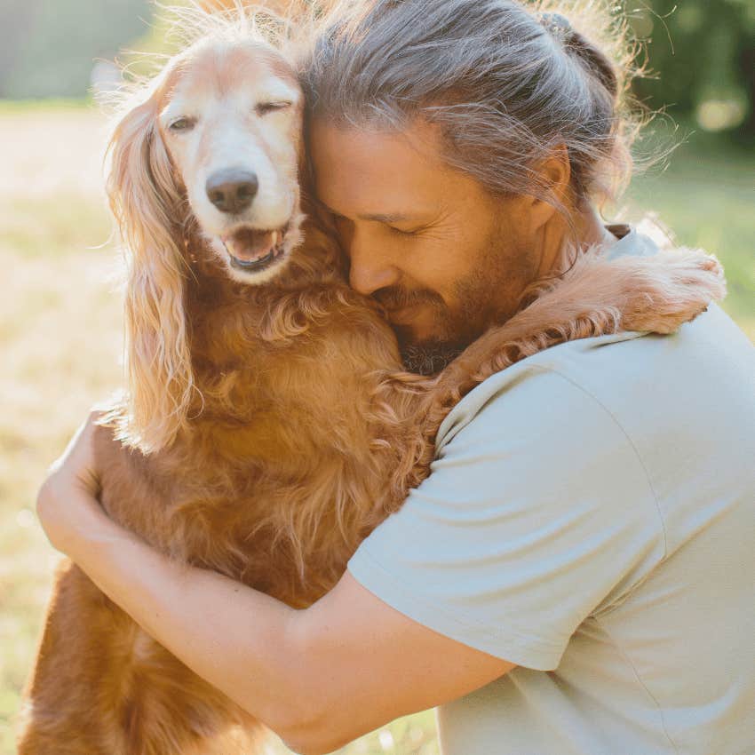 man hugging pet dog close