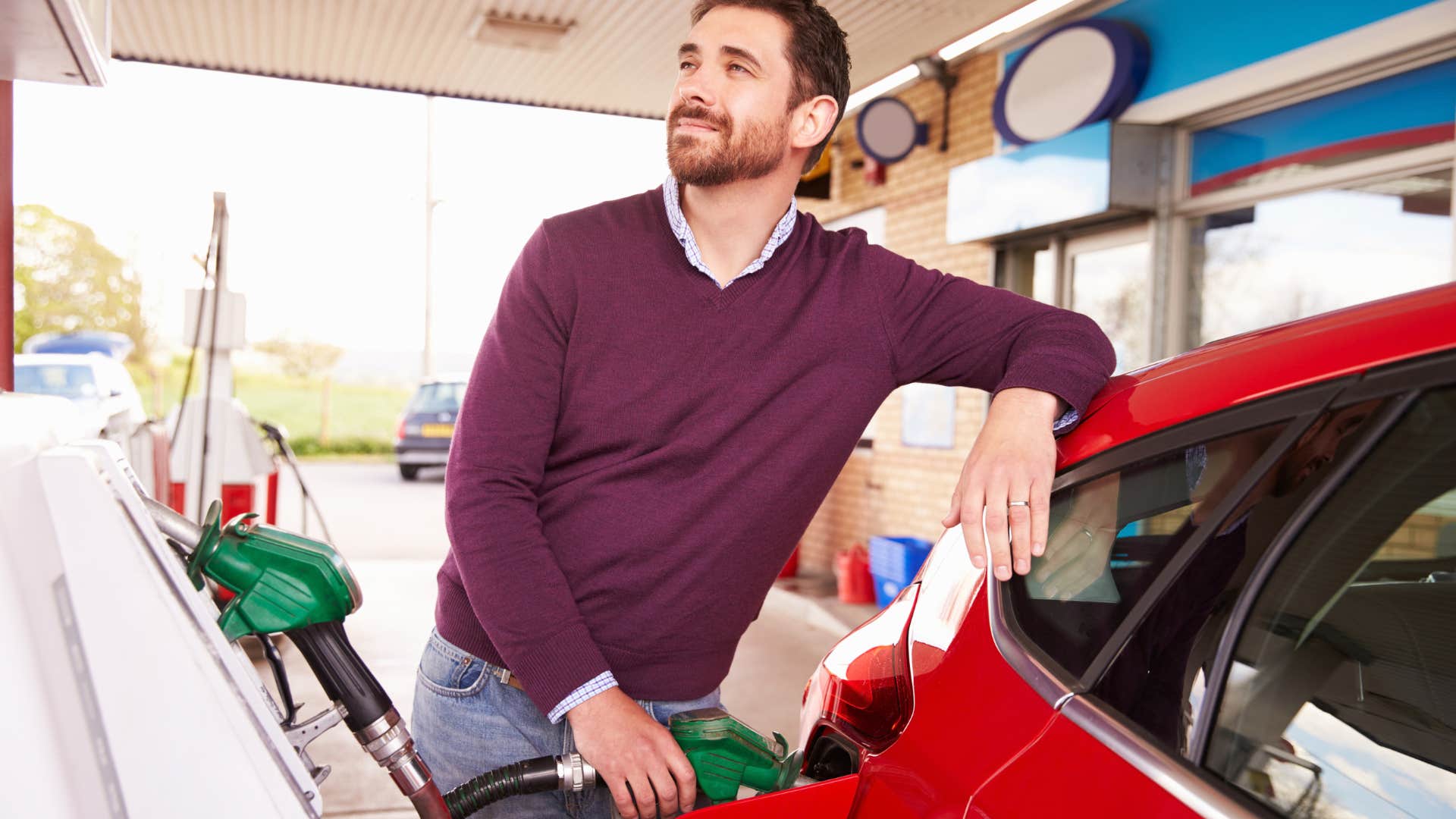 man who dreads quiet sundays filling up his car's gas tank