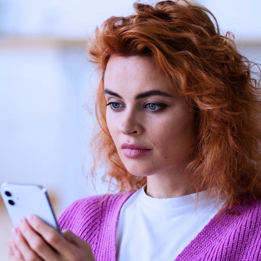 low-IQ woman on her phone accepting conspiracy theories without checking