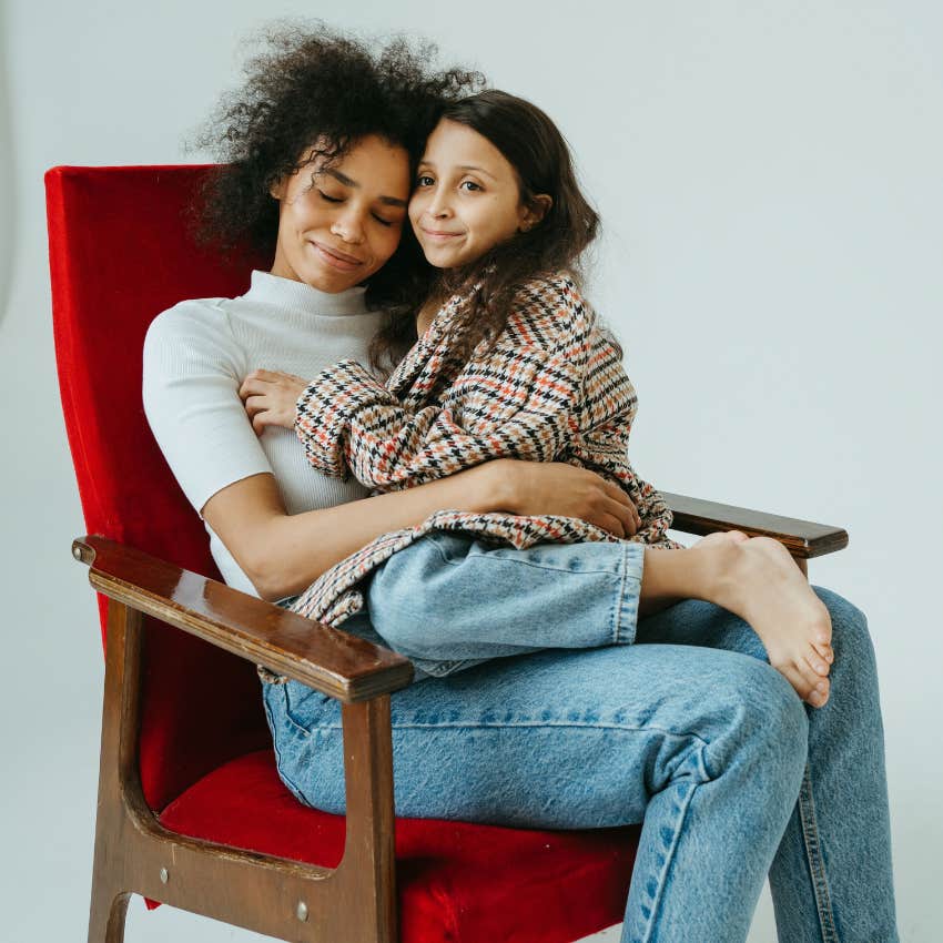 mom snuggling daughter taking care of her emotional needs