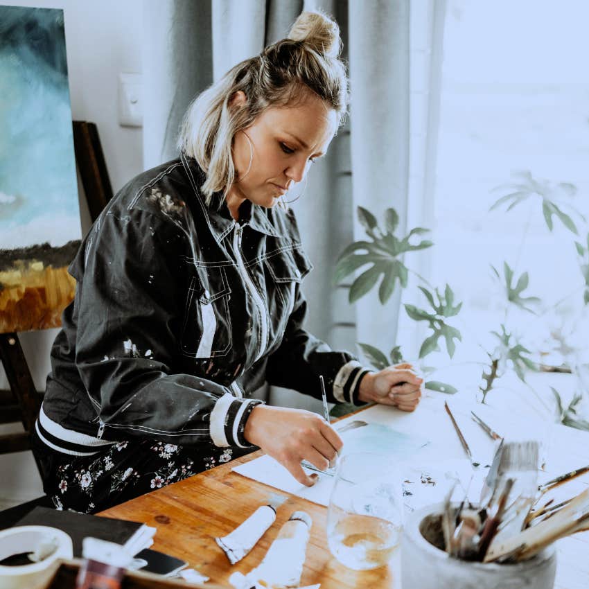 Gifted woman investing in niche hobbies at home.