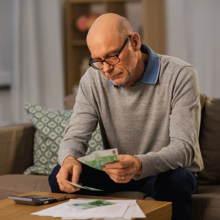 man keeping track of every dollar he makes and spends