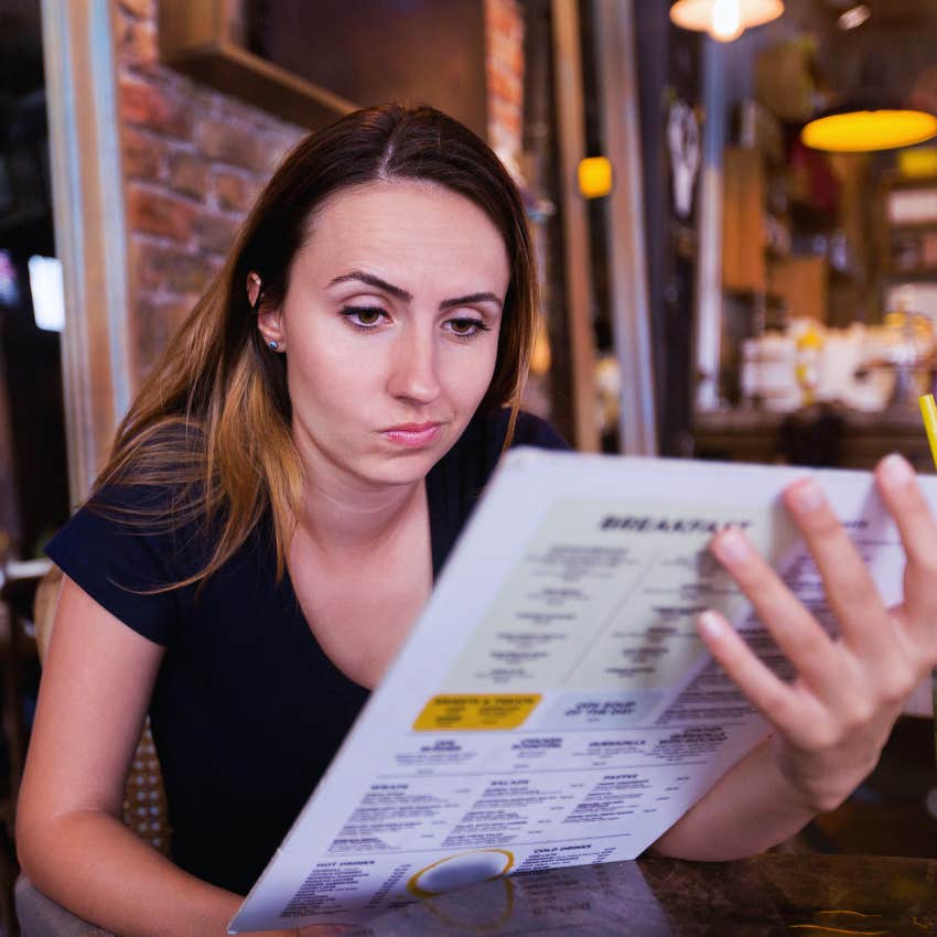 woman ordering the cheapest thing on the menu at restaurants