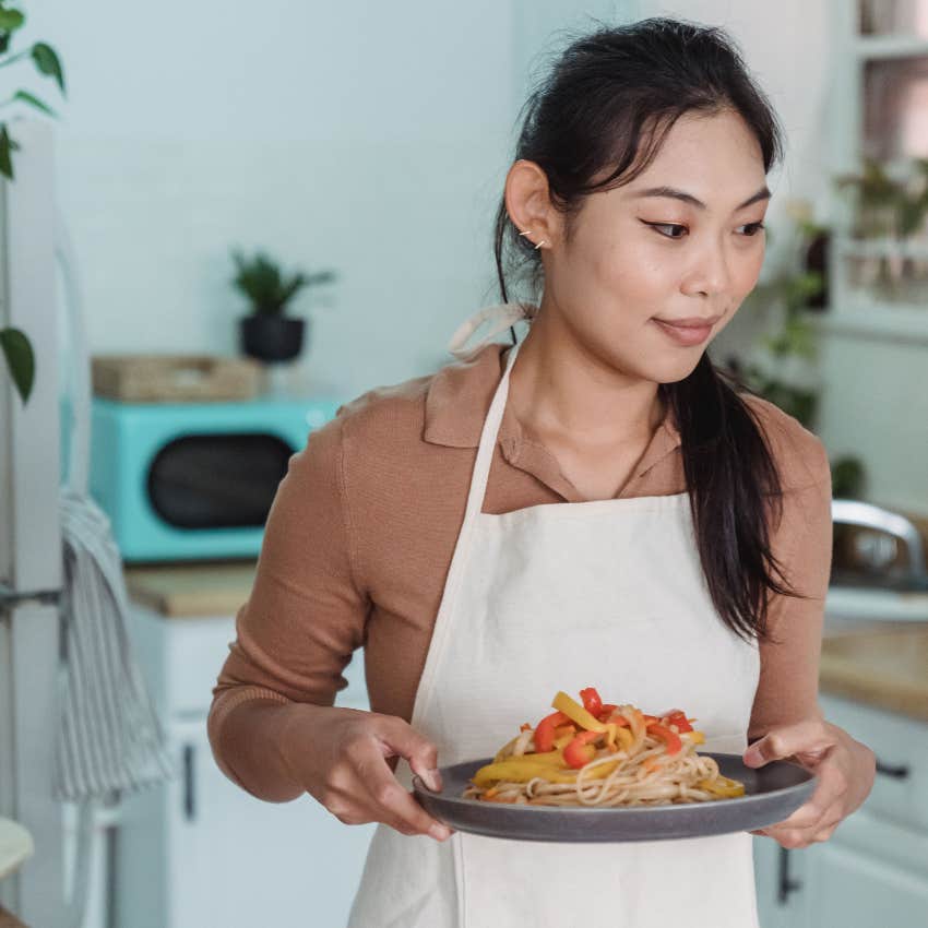 woman making a homecooked meal instead of eating out