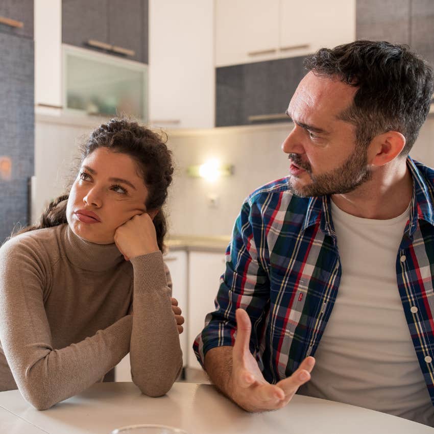 annoyed woman listening to man talk trying to one-up her in conversation