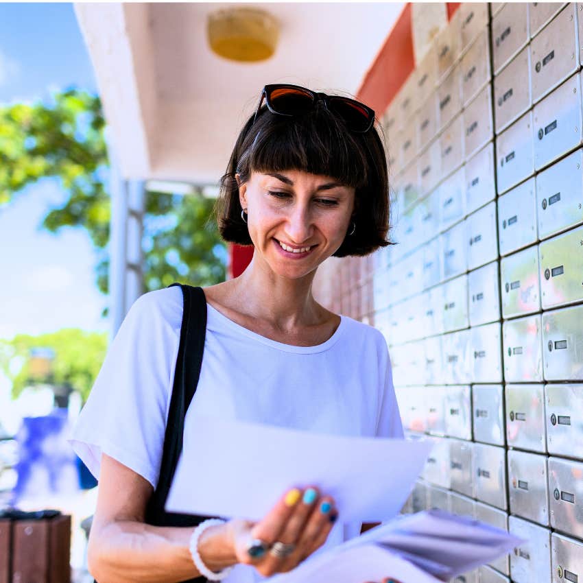 Gen X woman opening her mail keeping her mailbox clear