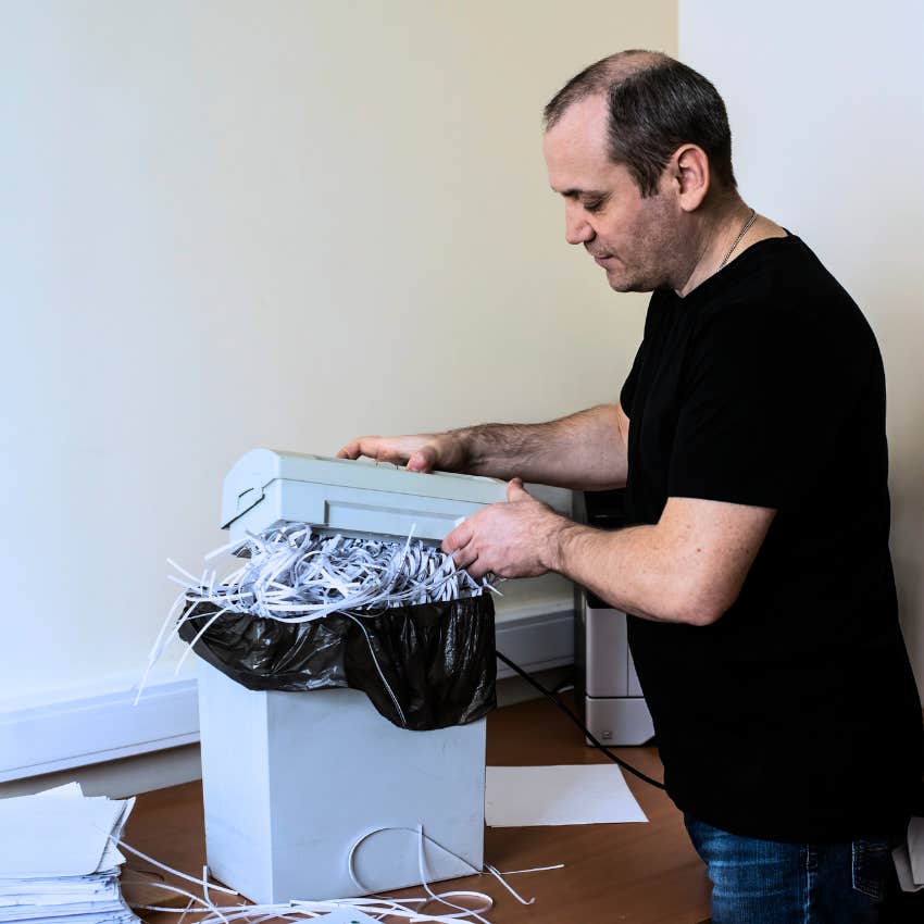 Gen X man shredding his mail before discarding it
