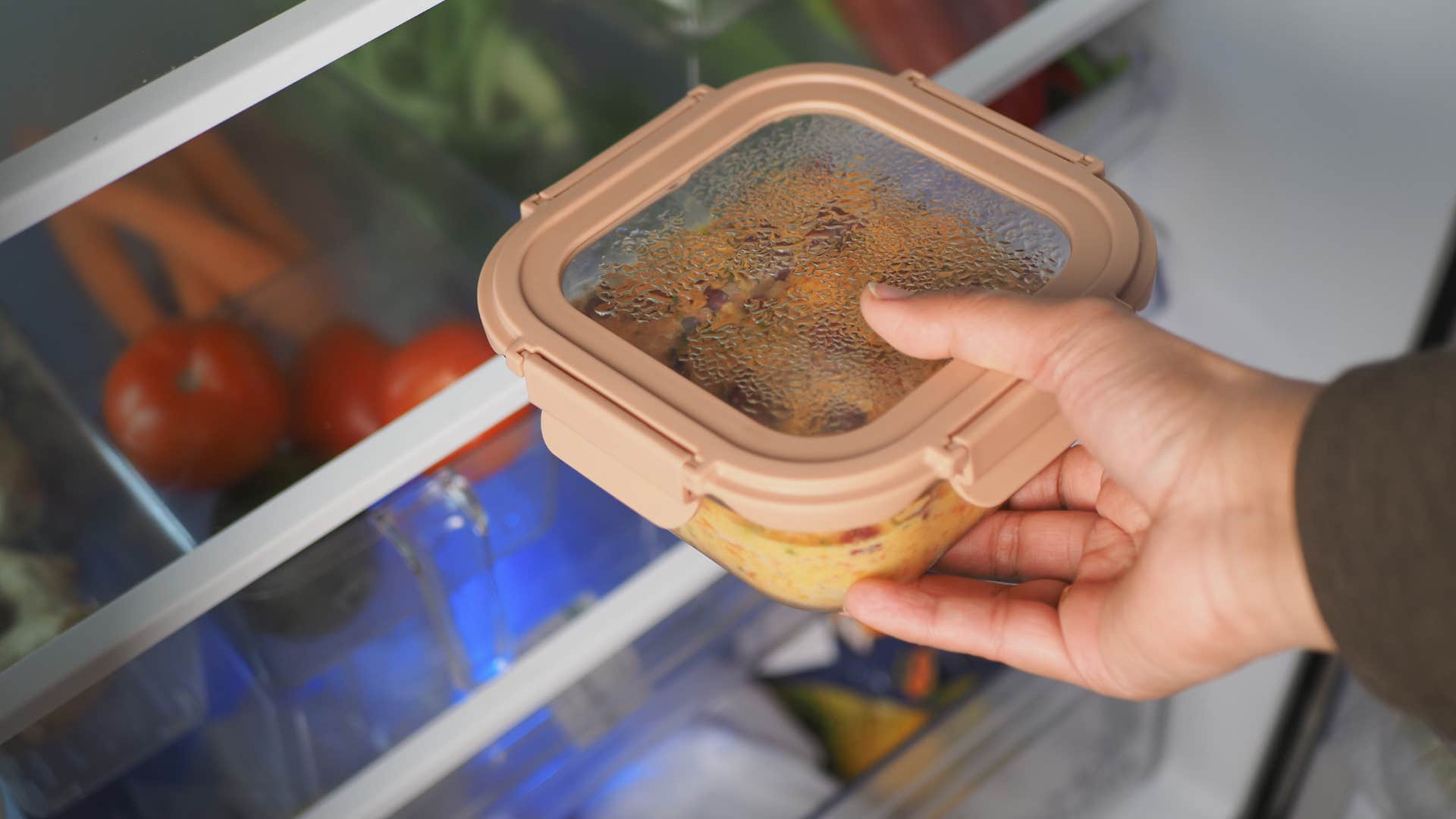 gen x woman putting away leftovers