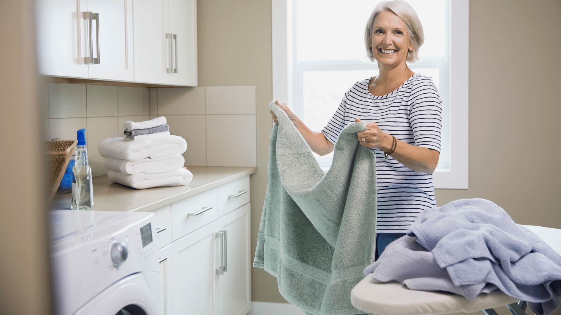 woman in blue shirt separating laundry by color before every wash