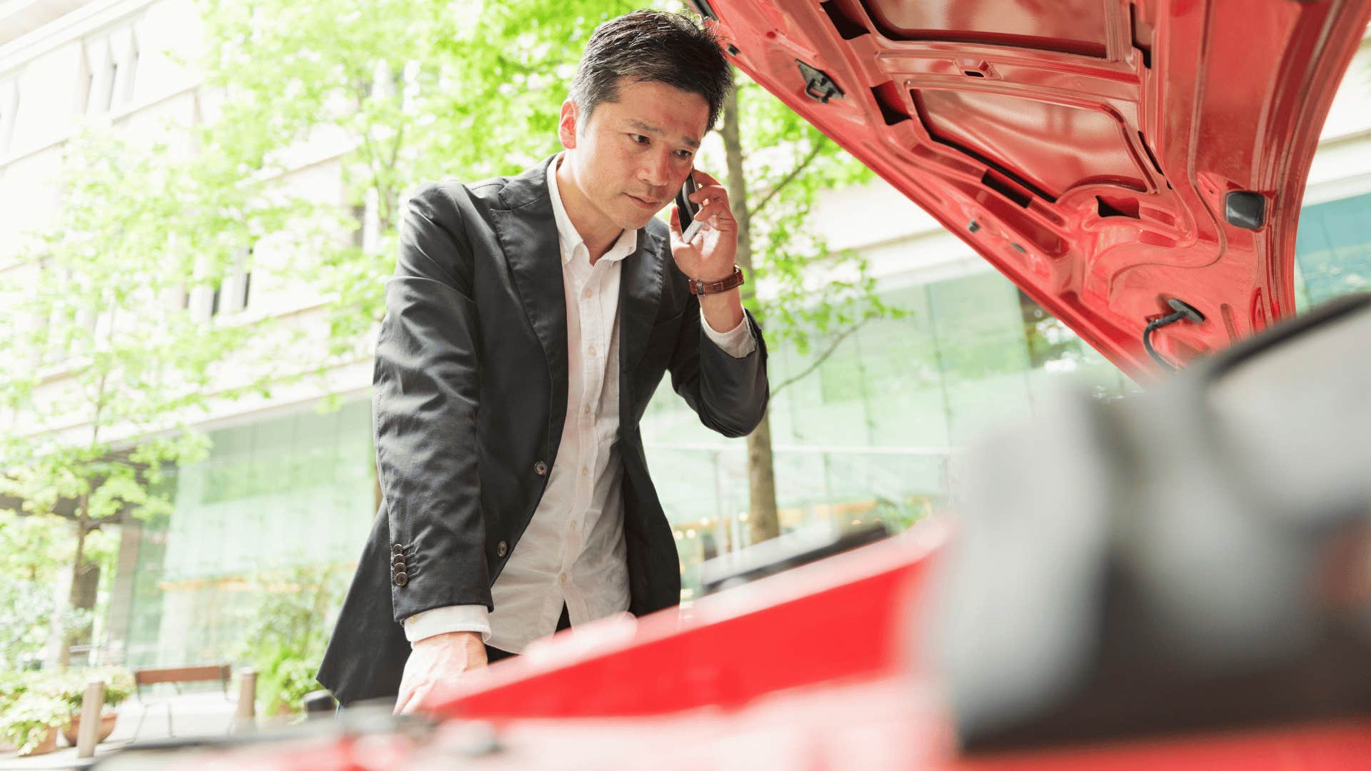 man checking a basic car problems