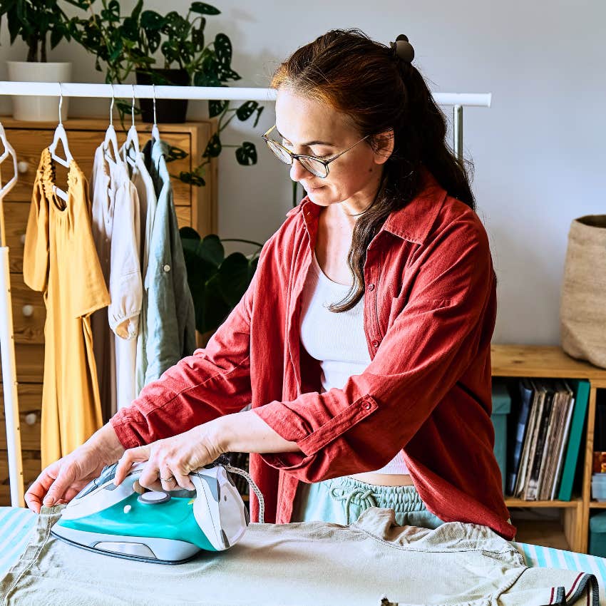 Gen X woman organizing and ironing practical items at home