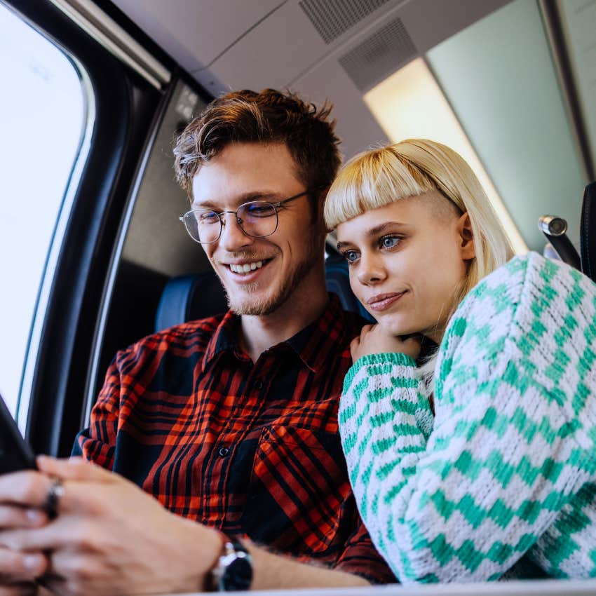 Gen Z couple cuddling on the train feeling stable in their relationship