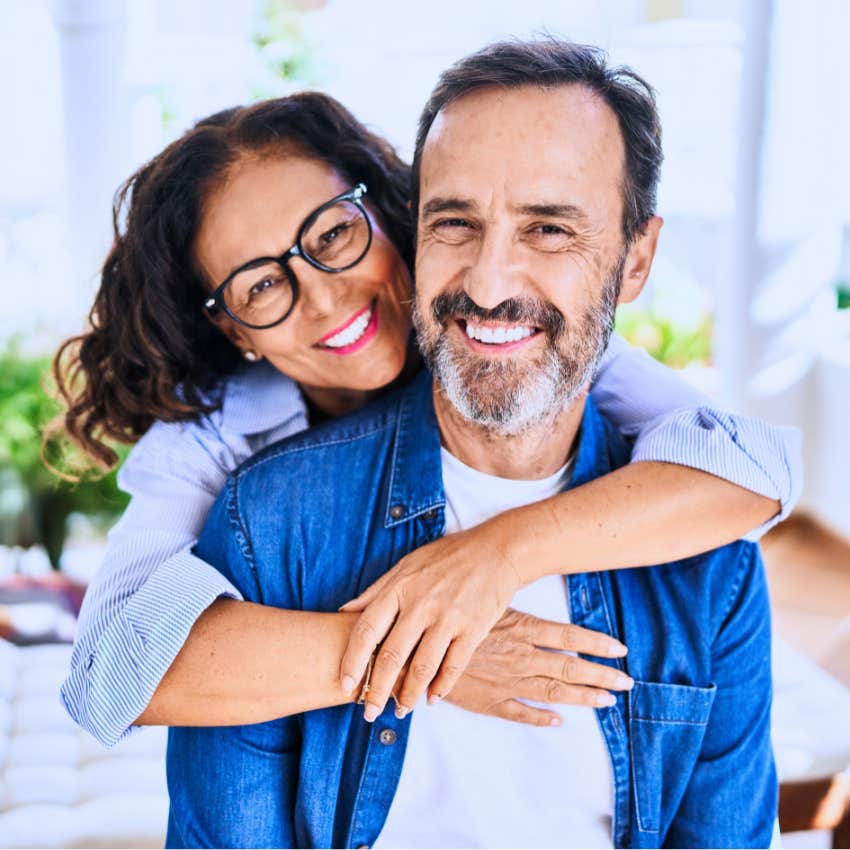practical Gen X couple appreciating stability and hugging