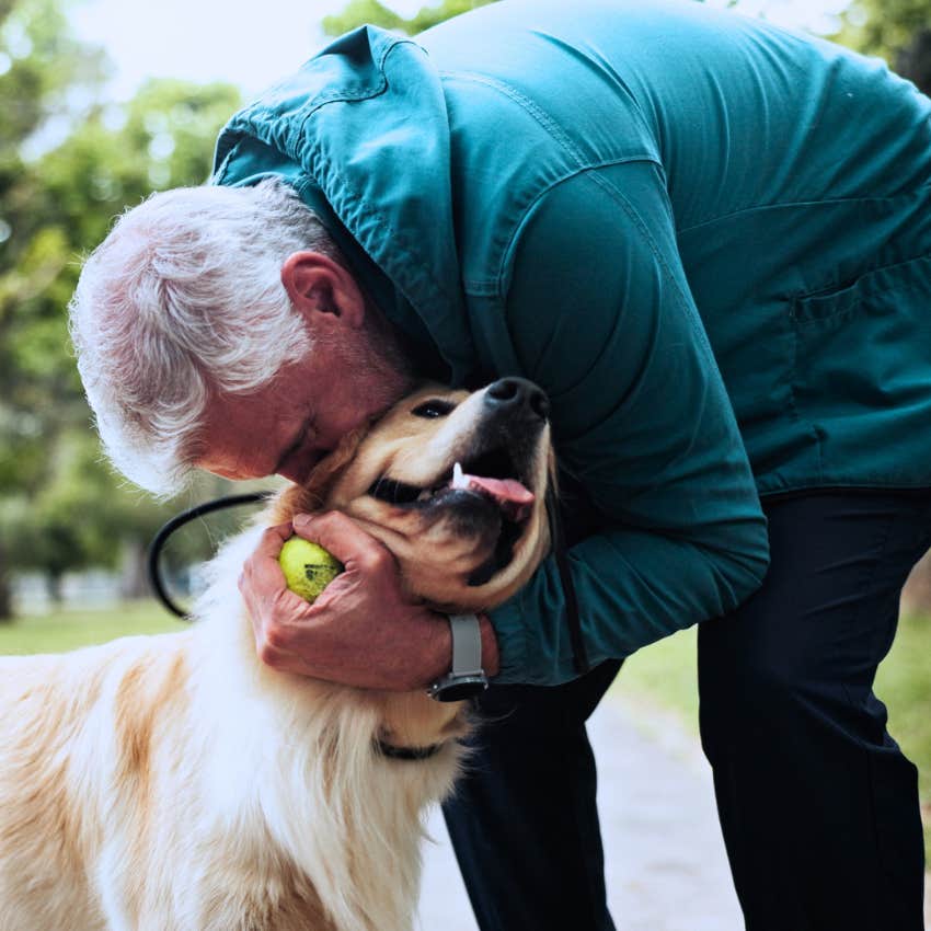 boomer man kissing his dog's head
