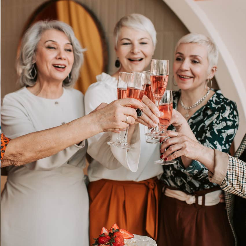 gen x women dressed up and clinking glasses
