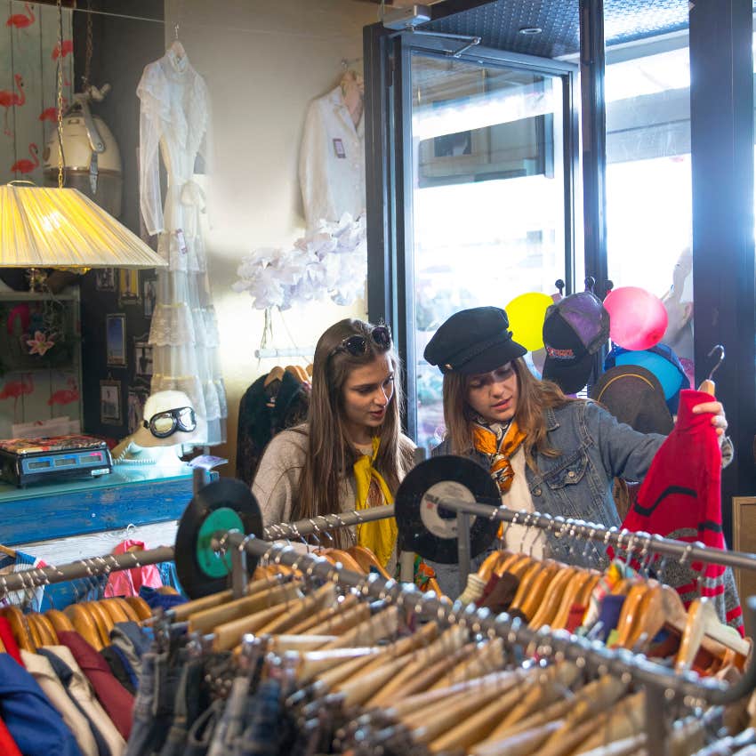 gen z women thrifting at a store for clothes