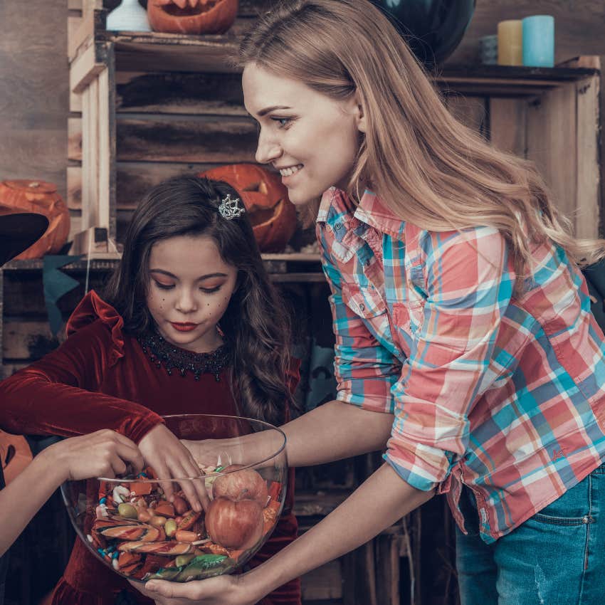 low-key gen X woman handing out halloween candy