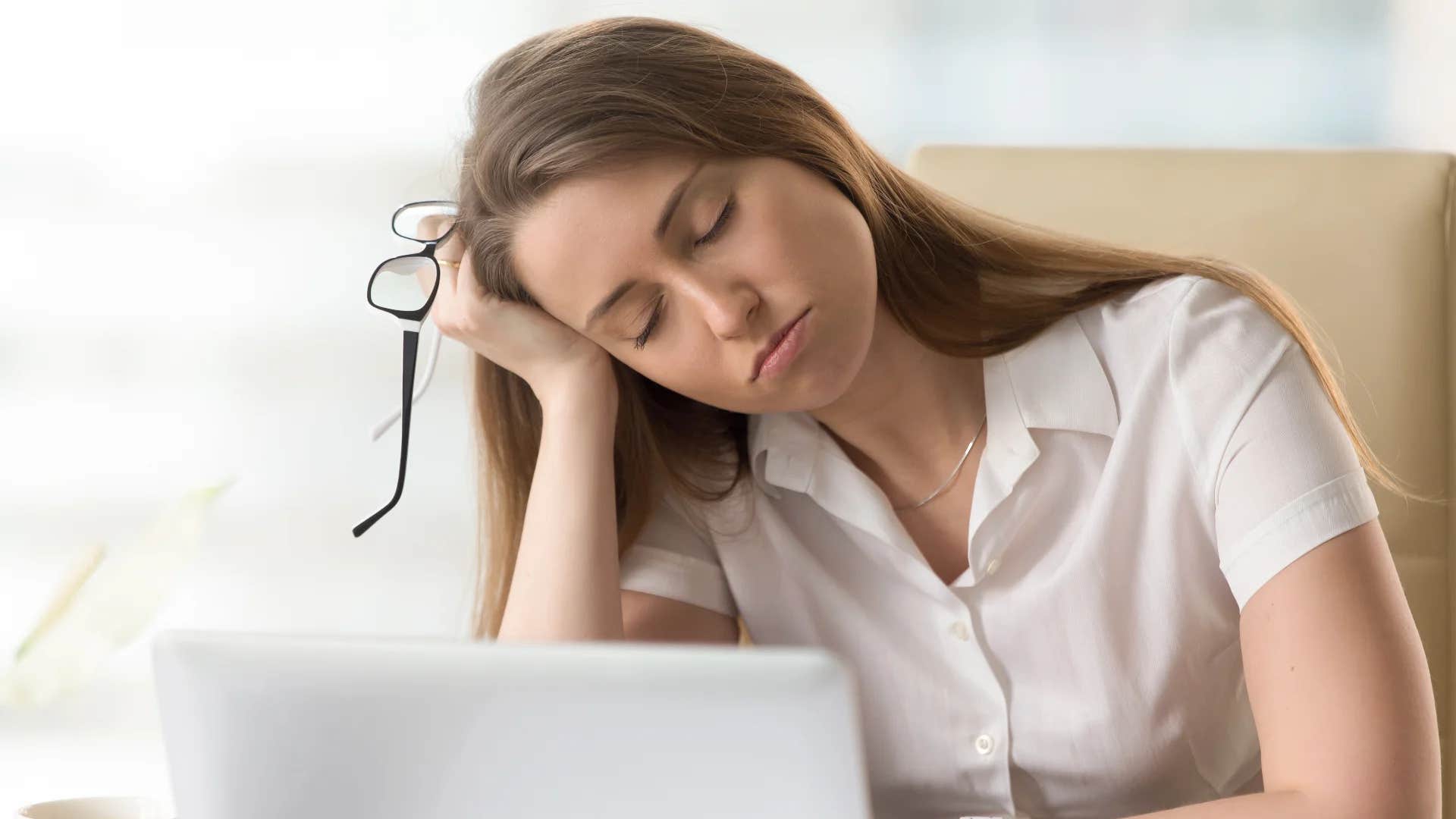 gen z woman falling asleep napping at work