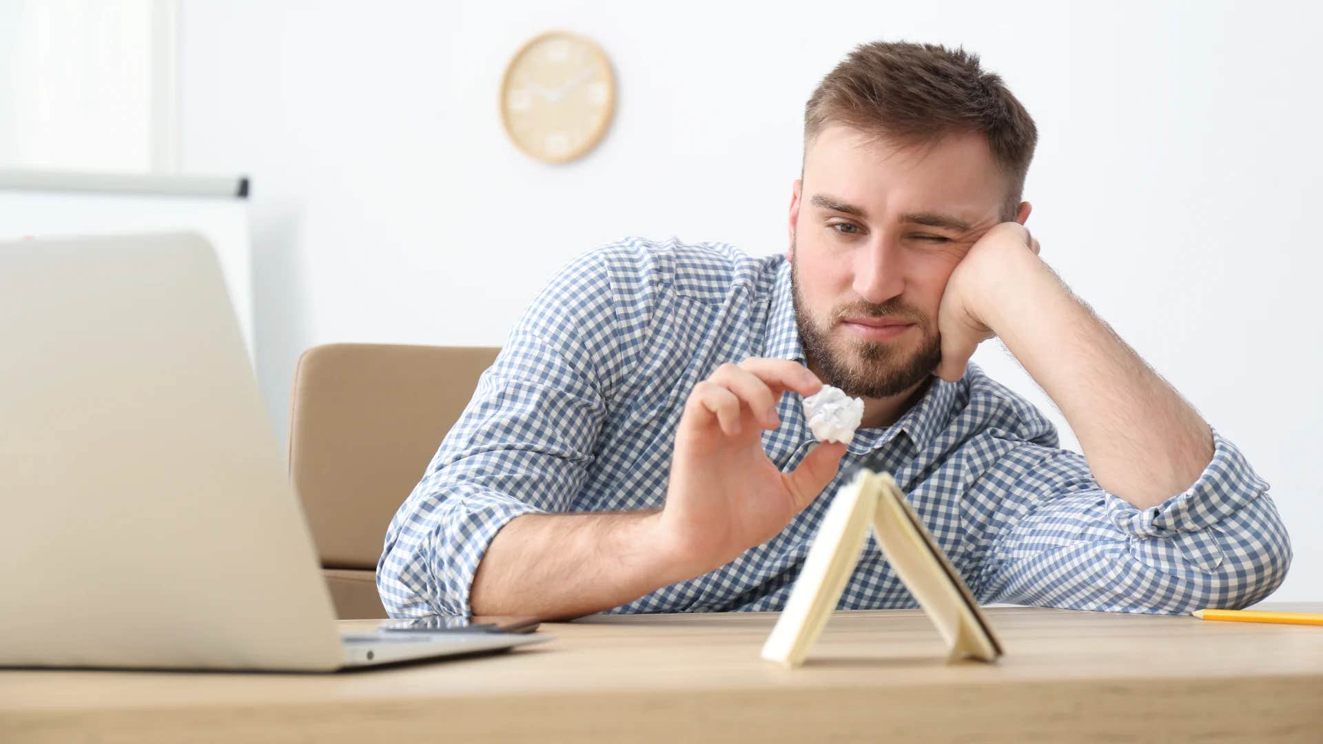man slacking off at work completely checked out and unmotivated