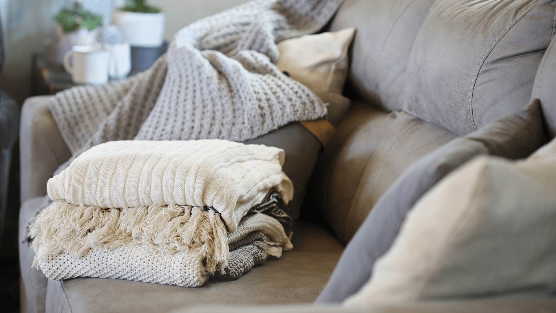 white and gray blankets on gray couch