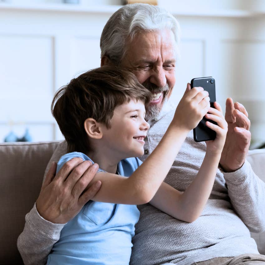 grandpa talking on the phone at home with grandchild