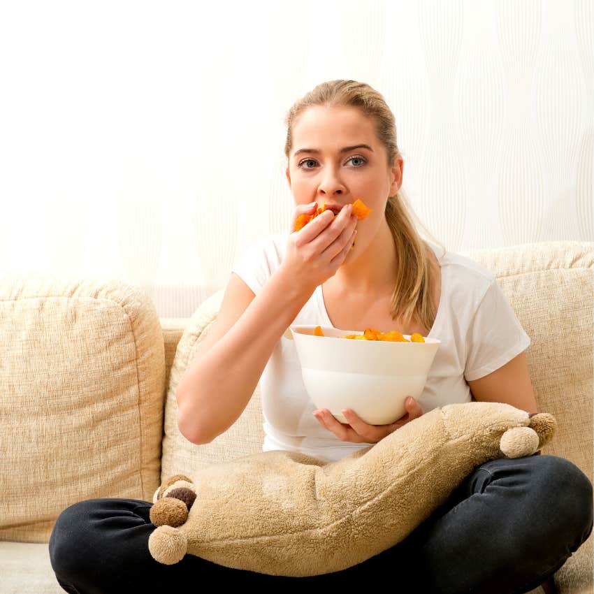 woman raised by narcissistic parents eating junk food to self-soothe