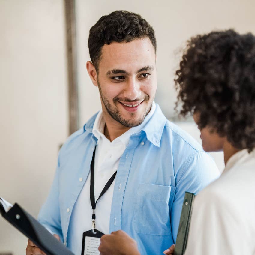 smiling man giving a backhanded compliment to his colleague