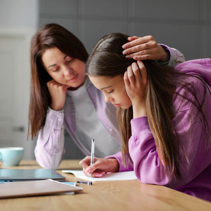 stressed out teen doing homework with helicopter mom who doesn't trust her to stay safe