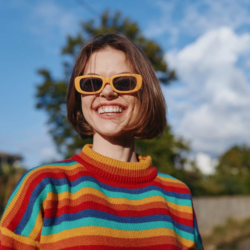 happy woman in orange sunglasses whose life flows naturally doesn't care what other people think of her