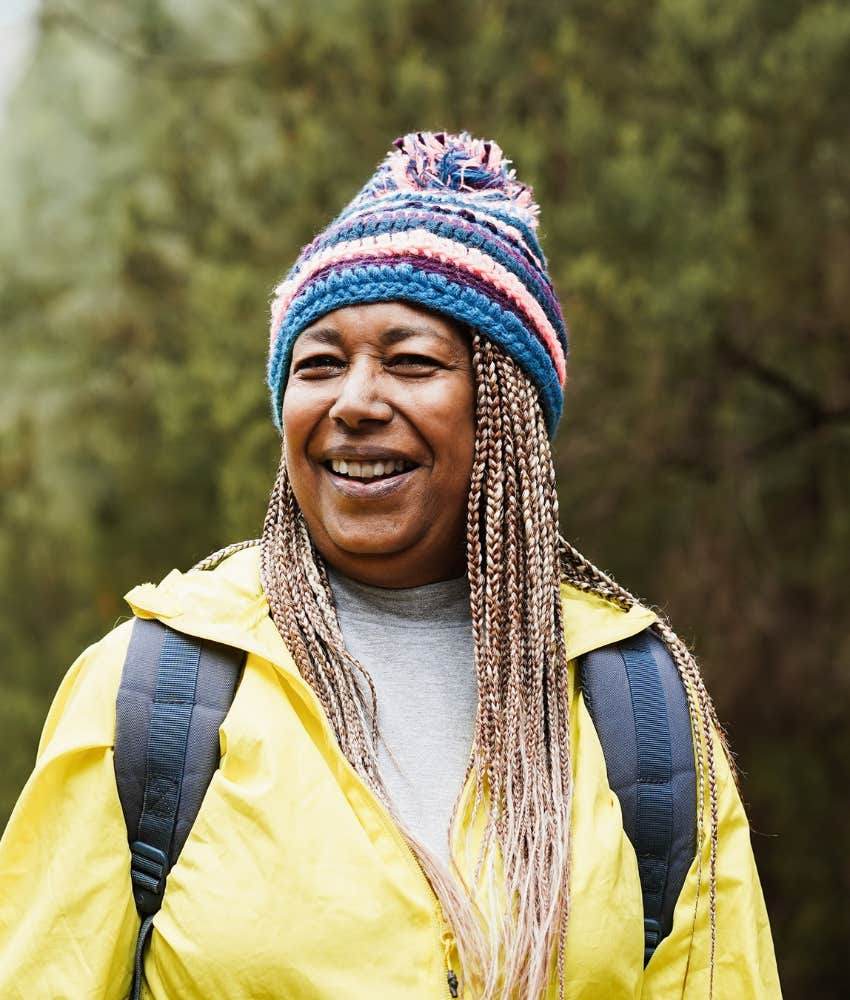 aging woman in knit hat smiles humbly 