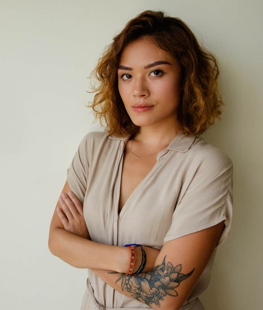 confident woman with arms crossed looking at camera