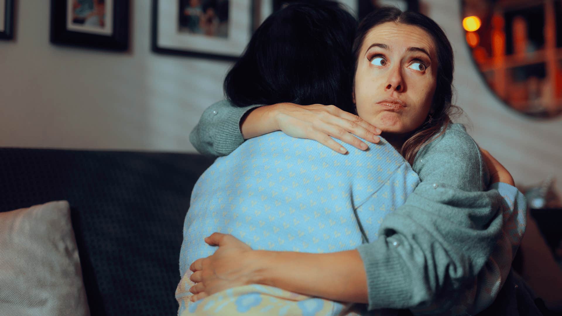woman acting differently depending on who's watching as she hugs friend secretly annoyed