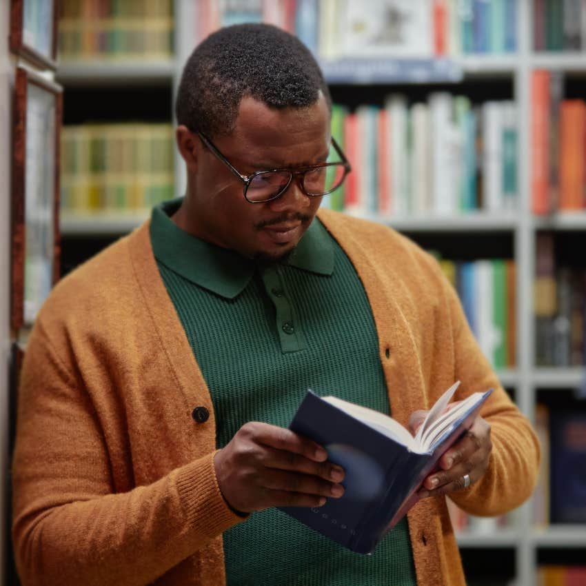 man who feels behind in life learning something new while reading in library