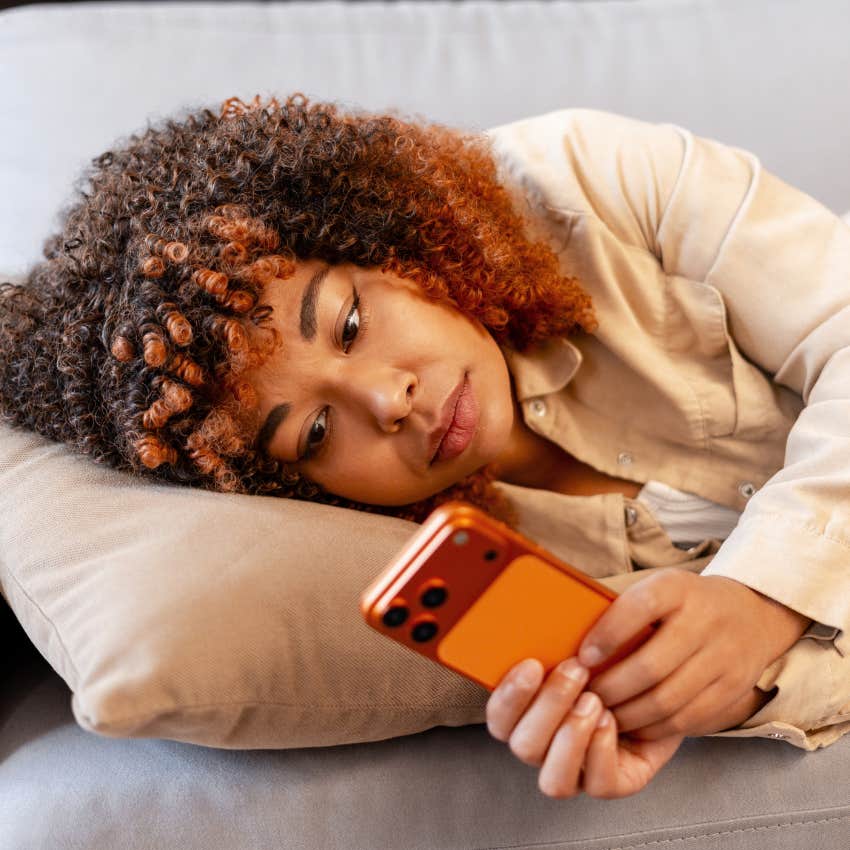 woman who hates being bored scrolling on her phone