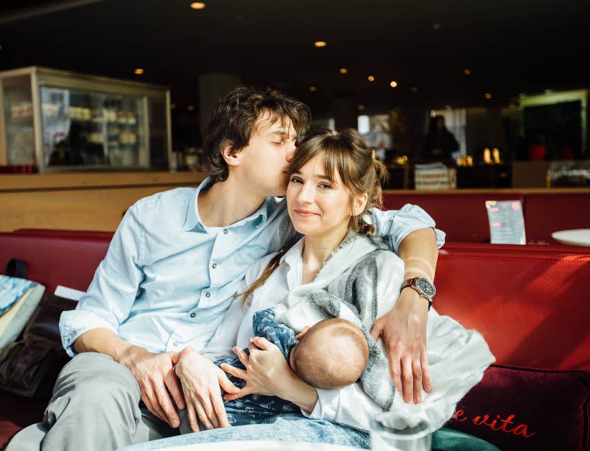 parents who are madly in love hold their baby