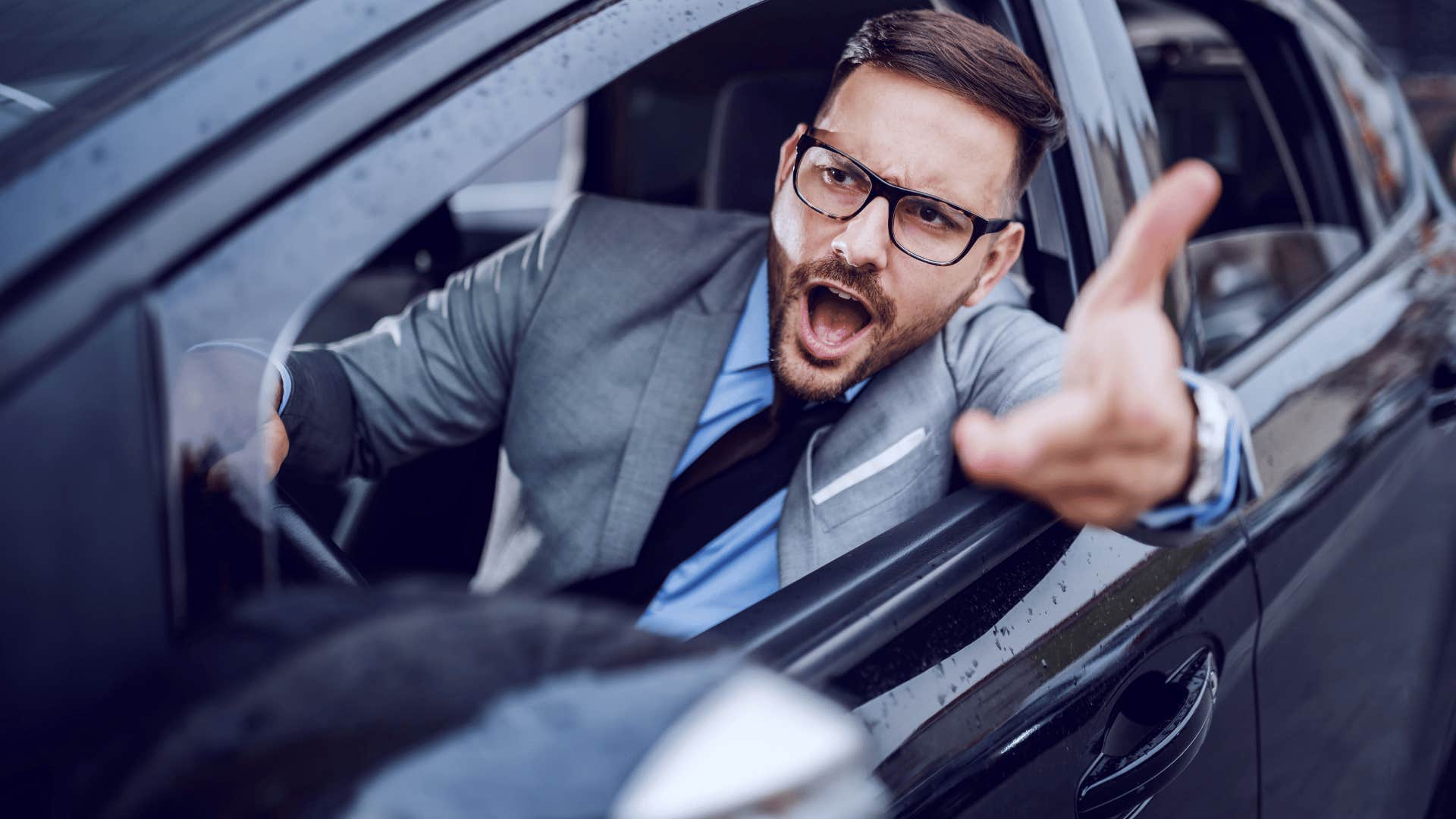 man in suit yelling out of car as they're impulsive
