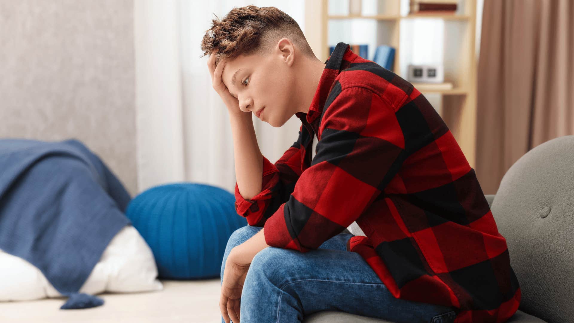 teenage boy with plaid shirt upset as he was told stop making a big deal out of everything