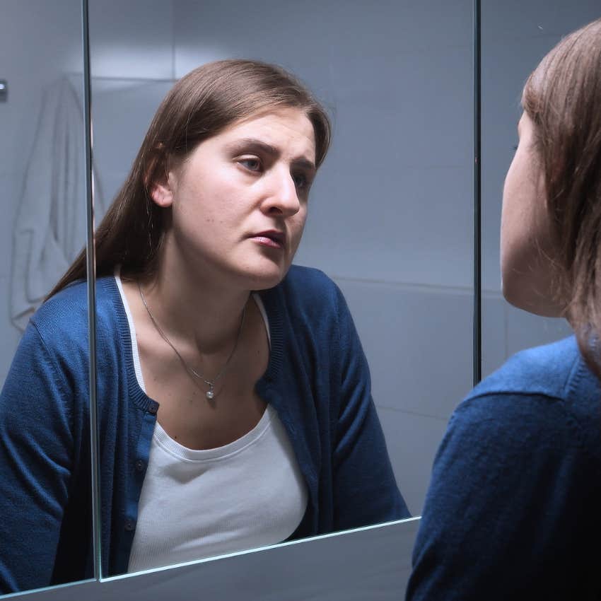 Woman never enjoying dressing in flattering clothing at home.