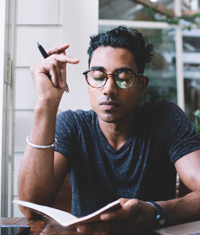 man sitting alone with a notebook