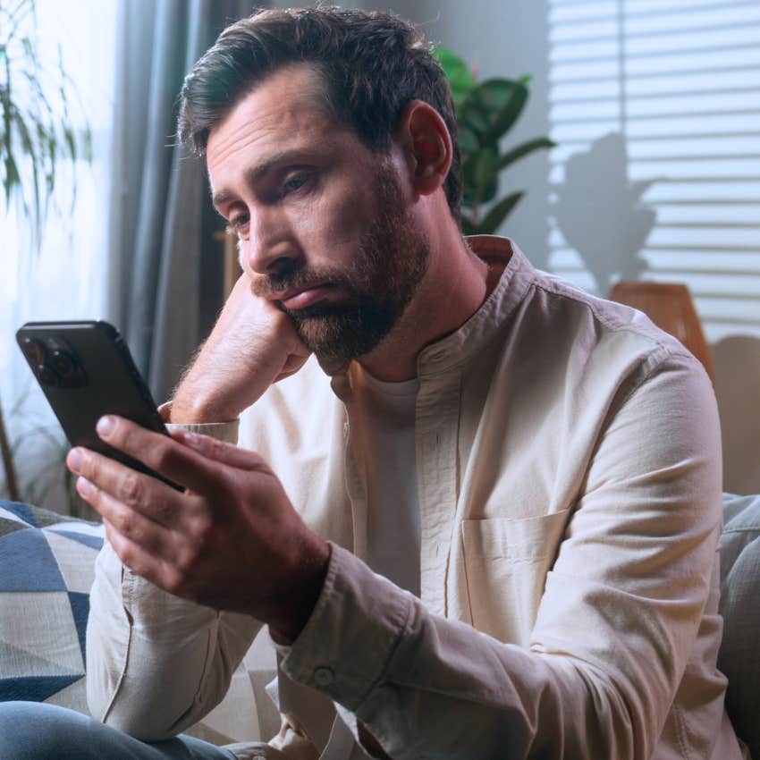 Struggling man comparing their lives to others on his phone.