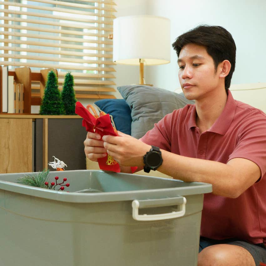 organized man putting his christmas decor in storage bins