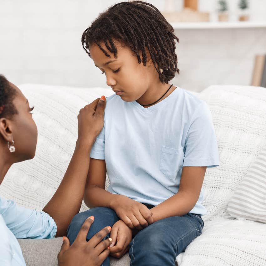 mom telling her child no while talking kindly to him 