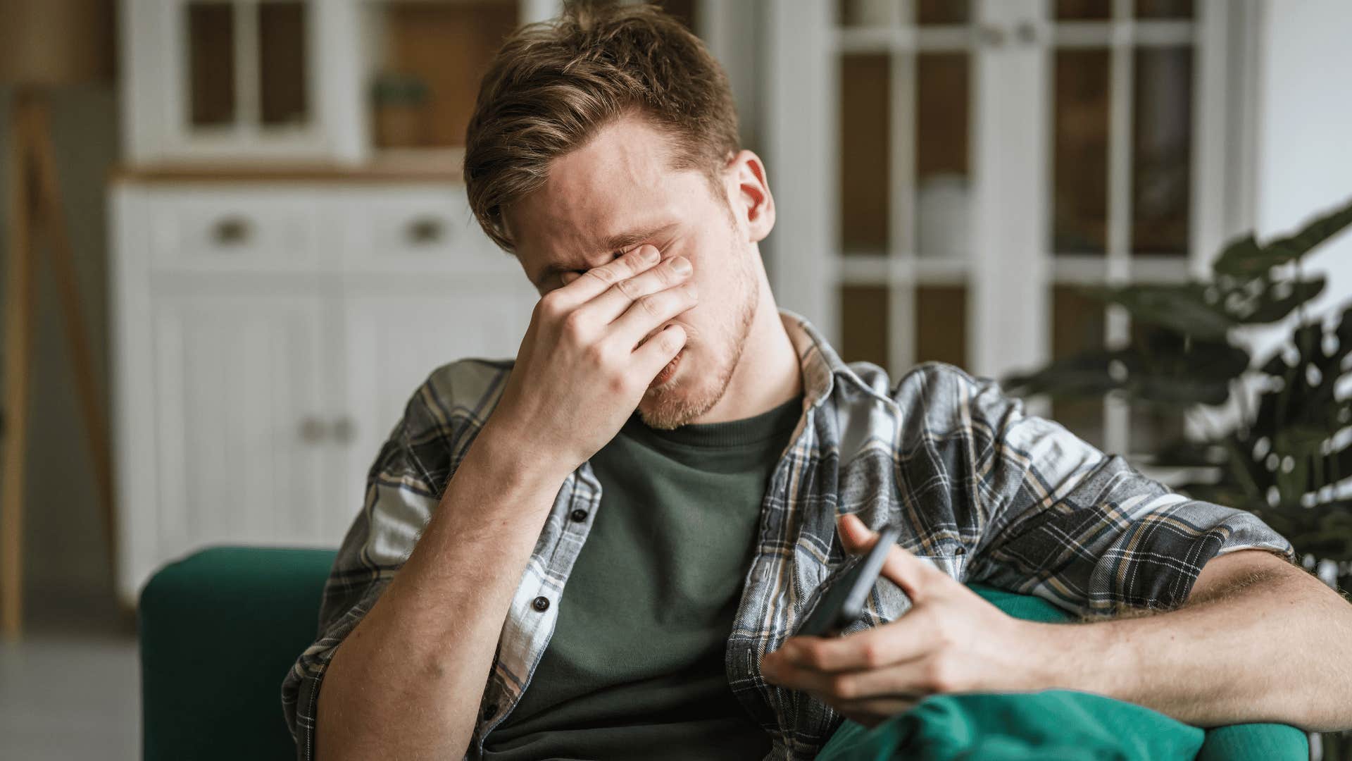 man covering face as he thinks i'm probably overthinking it