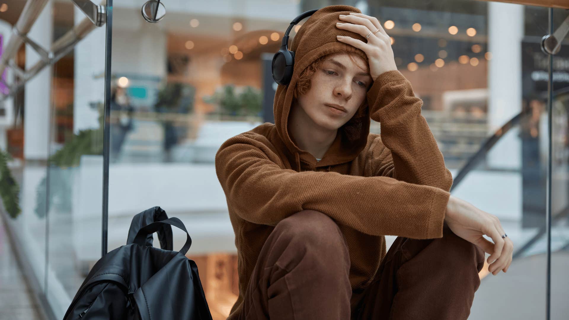 teenage boy at mall being made to feel guilty for needing necessities