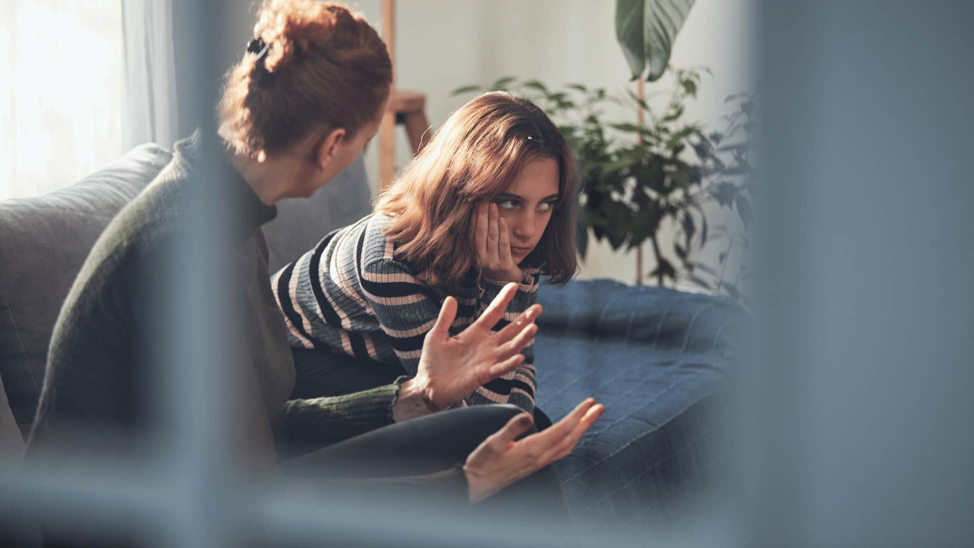 mother arguing with teenage daughter as daughter has their accomplishments overlooked