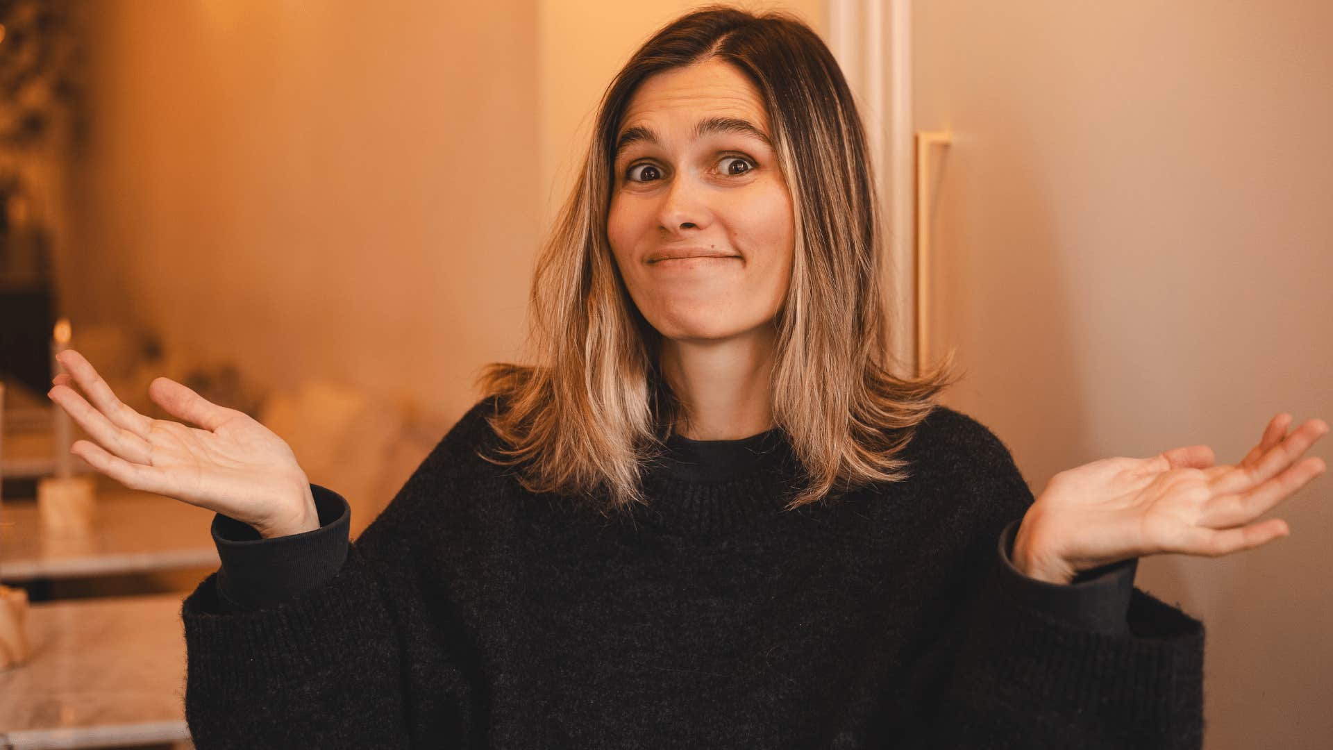 woman in black shirt shrugging as she thinks people are just jealous of me