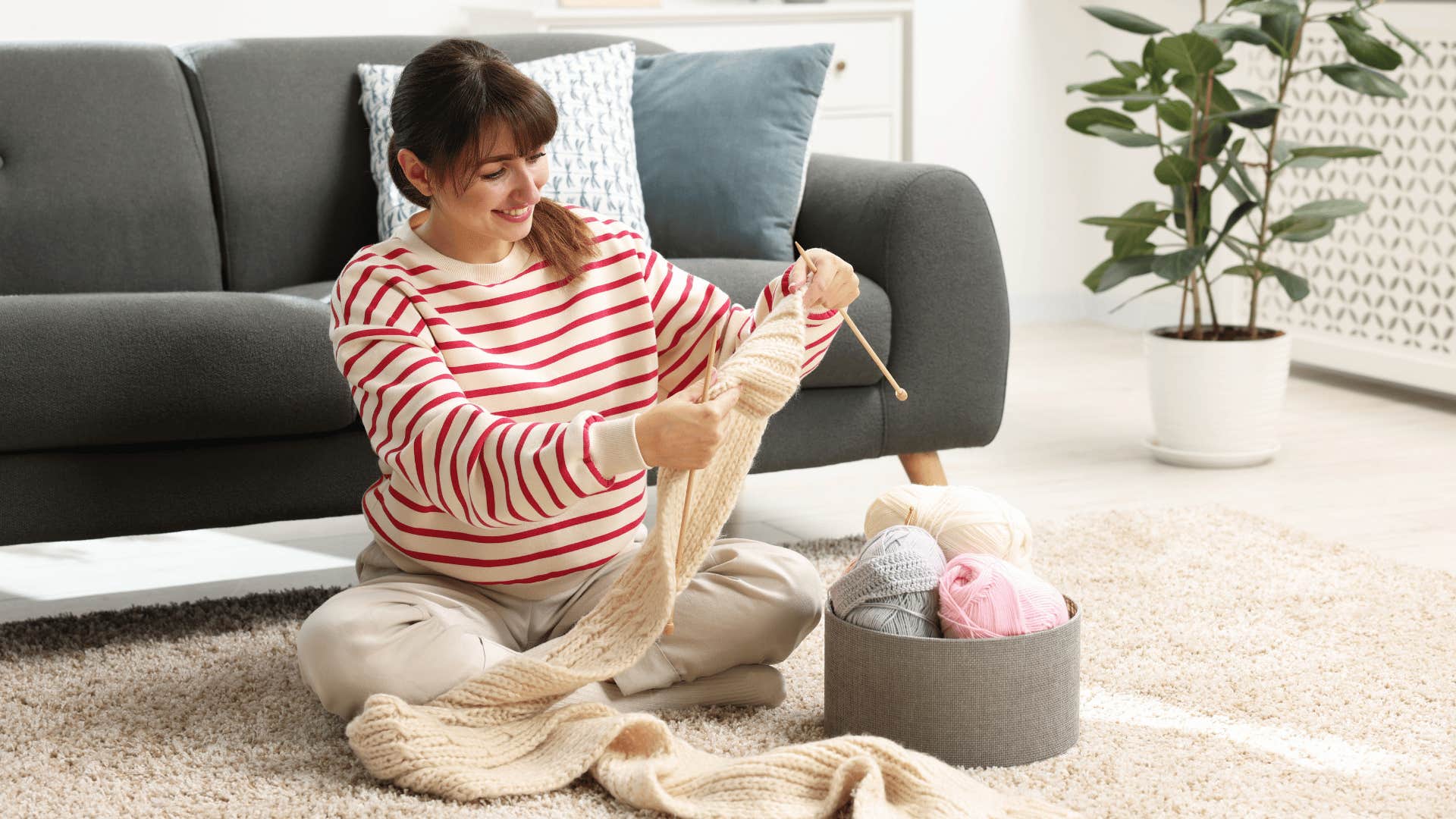 woman in stripped shirt crocheting