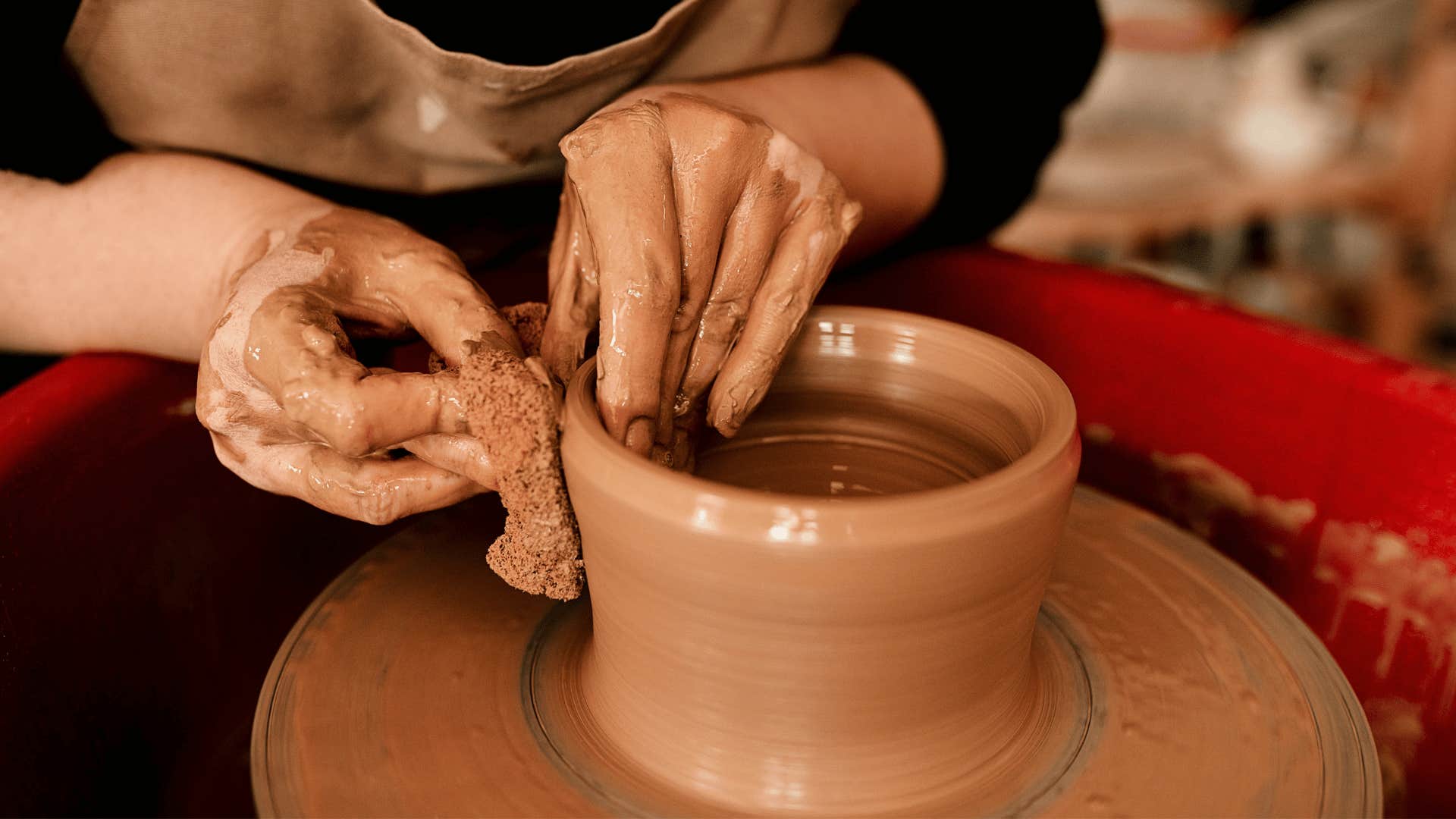 woman in black shirt doing pottery