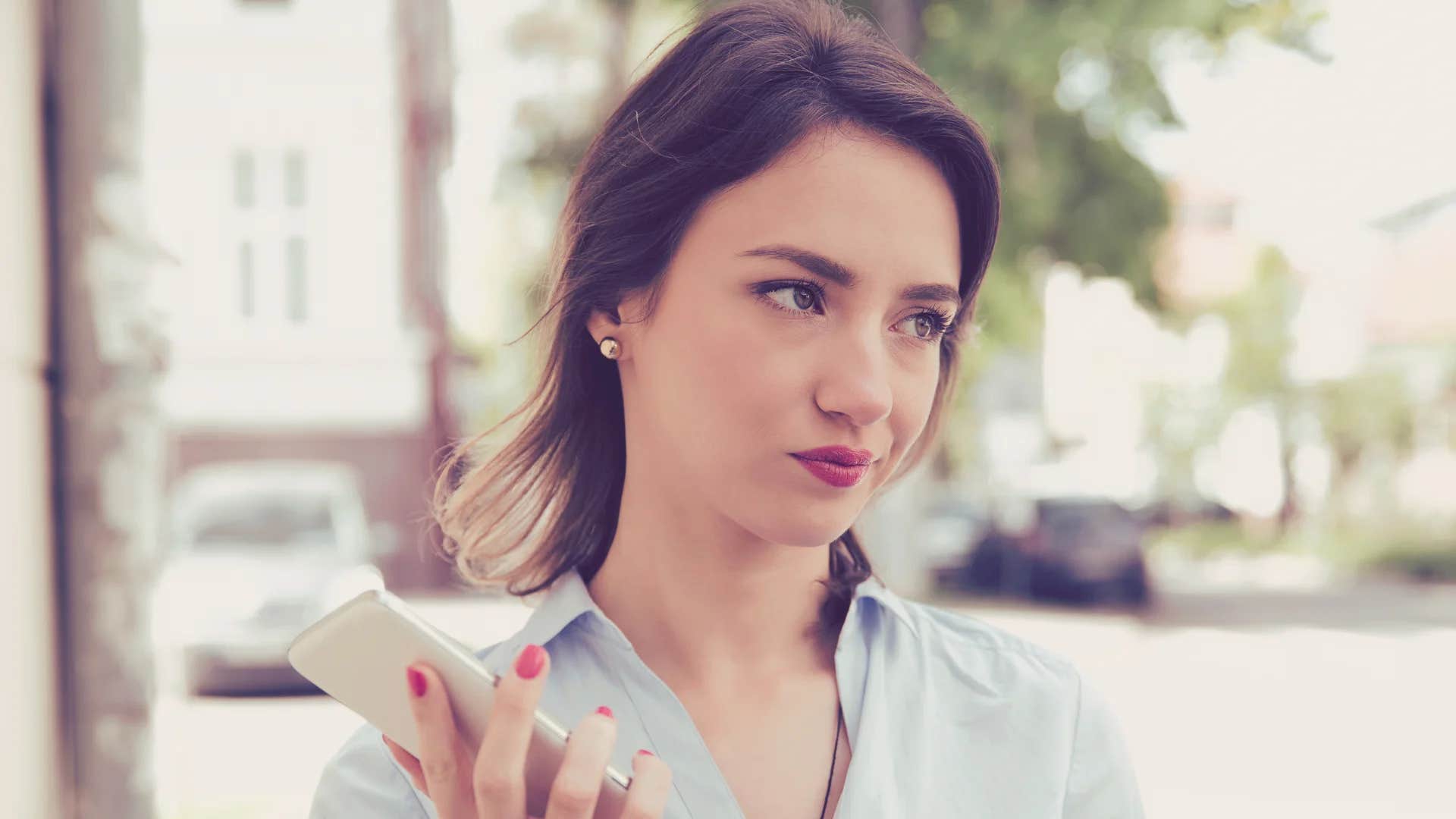 woman who is about to be ghosted on phone being told let's catch up soon