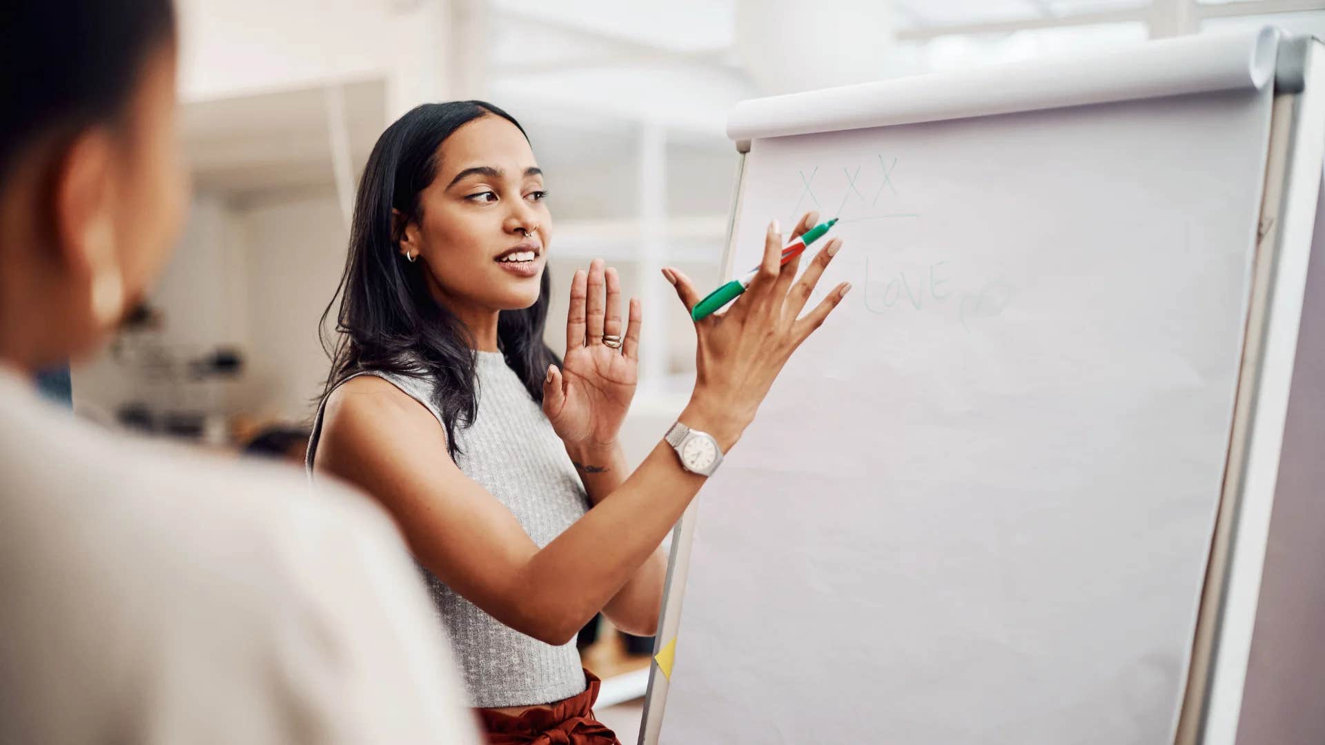 woman trying to sound smart telling colleague it begs the question